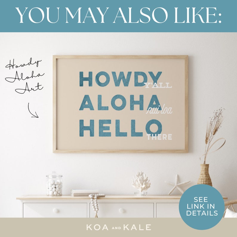 May include: A framed print with a beige background and blue text that reads "Howdy Y'all Aloha Nui Loa Hello There". The print is hanging on a white wall above a white dresser with a vase of dried flowers and a bowl of white decorative balls.