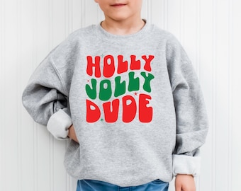 May include: A gray sweatshirt with the text "HOLLY JOLLY DUDE" in red and green letters. The letters are in a retro font style.