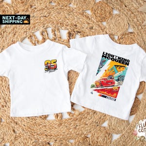 May include: Two white t-shirts with Lightning McQueen designs. One has the number "95" and "Lightning McQueen" text. The other features a colourful graphic of Lightning McQueen racing, with the text "Lightning McQueen" and "Cars".