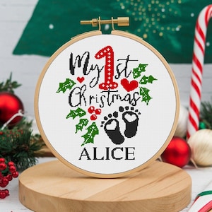 May include: White embroidery hoop with a red and green Christmas design that says "My 1st Christmas" with a pair of baby footprints and the name "Alice".