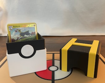 May include: A white and black Pokemon deck box with a Pokeball design on the lid, a black and yellow deck box with a letter H on the lid, and a brown Pokemon playmat with a red and white Pokeball design.