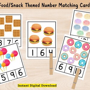 May include: Food/Snack themed number matching cards featuring illustrations of waffles, burgers, donuts, and lollipops. Each card displays a different number of food items, with corresponding numbers below. The phrase "Instant Digital Download" is also visible.