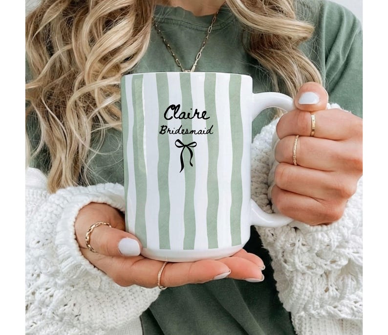 Striped pastel ceramic mug with black bow and custom text for bride, bridesmaid, or maid of honor; perfect as personalized bridal gift.
