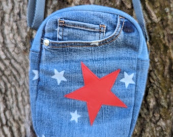 Cell phone crossbody purse with star detail made from upcycled denim.