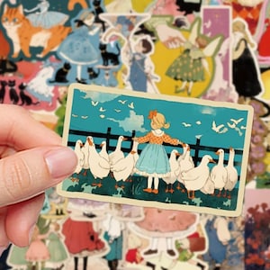 May include: A rectangular sticker featuring an illustration of a blonde child in a blue dress and orange patterned top standing before a black fence, surrounded by a flock of white geese against a teal sky with white birds flying overhead.