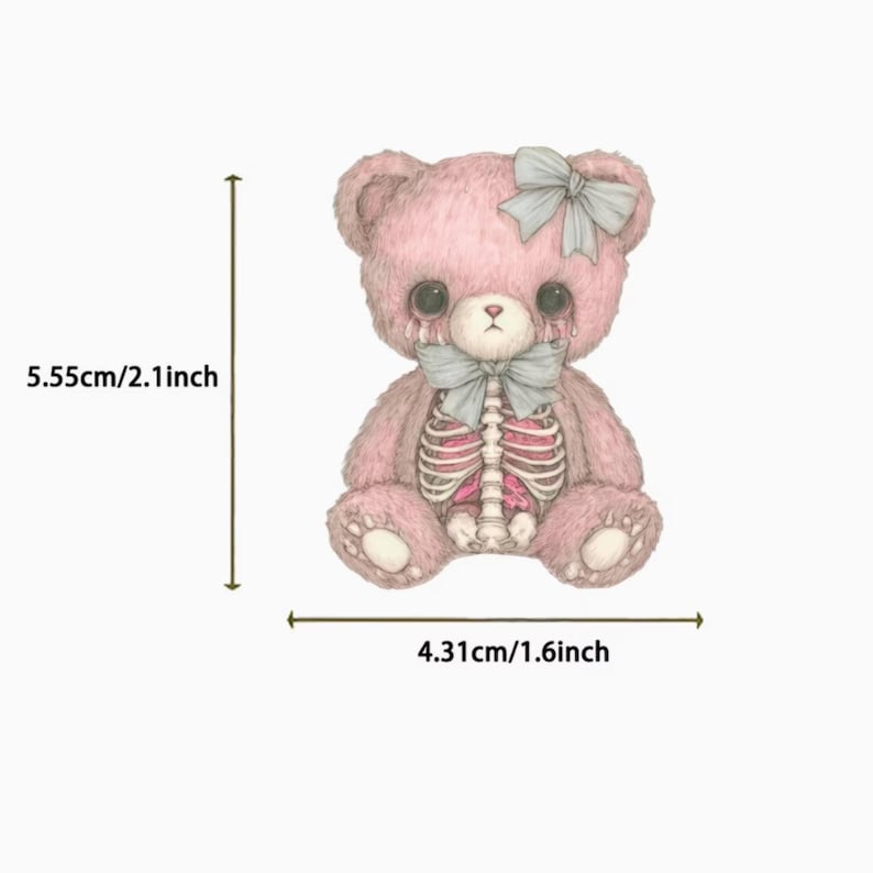 May include: A pink teddy bear illustration with a skeleton design, measuring 2.1 inches tall and 1.6 inches wide. The bear has a gray bow on its head and chest, with tears drawn on its face. The design is on a white background.