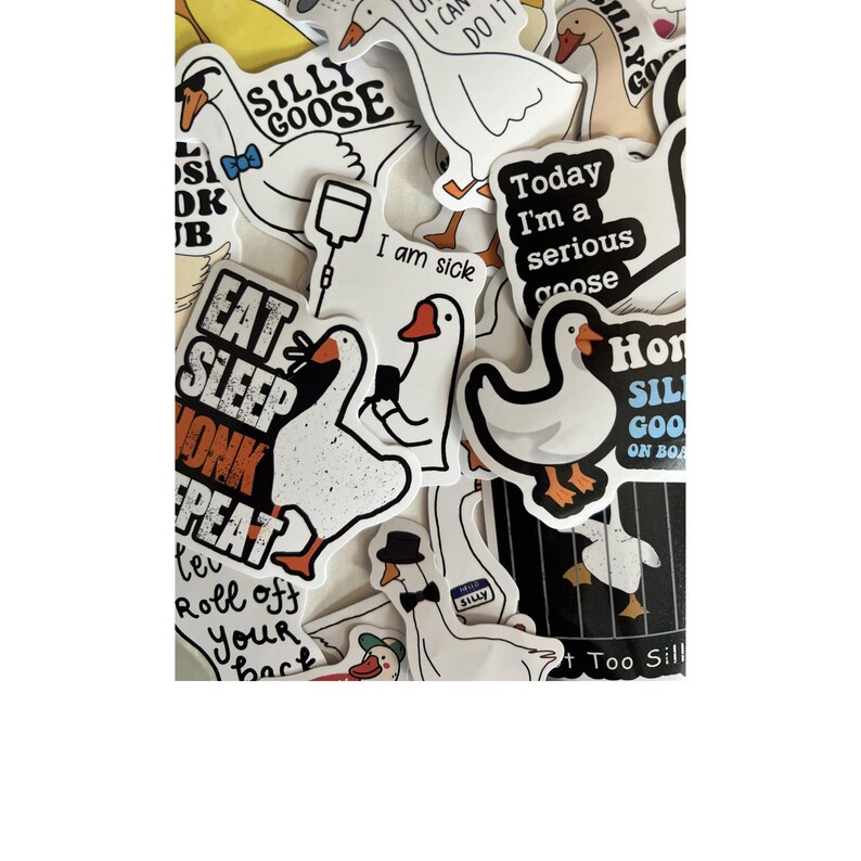 Op de afbeelding: Een verzameling witte stickers met cartoon ganzen in verschillende poses. Sommige stickers hebben tekst als "Silly Goose", "Eat Sleep Honk Repeat" en "Today I'm a serious goose". De ganzen hebben oranje snavels en poten.