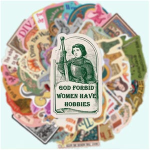 May include: A sticker featuring a green-toned illustration of a knight in armour holding a sword, with the text "GOD FORBID WOMEN HAVE HOBBIES" printed below. The sticker is layered over a collection of various other colourful, assorted stickers.