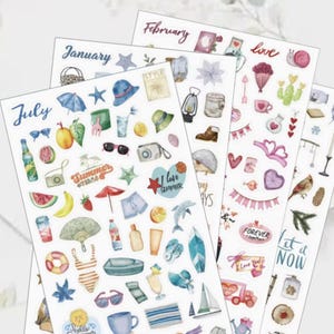 May include: Four sheets of decorative stickers with various summer and seasonal designs. The stickers include images of a beach umbrella, sunglasses, fruit, and the words "Summer" and "July". Other sheets are labeled "January" and "February".