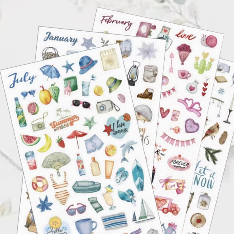 May include: Four sheets of decorative stickers with various summer and seasonal designs. The stickers include images of a beach umbrella, sunglasses, fruit, and the words "Summer" and "July". Other sheets are labeled "January" and "February".