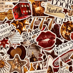 May include: A collection of assorted stickers featuring a red die, gold stars, a disco ball, a pair of red lips, a wax seal, a martini glass, and text phrases including "Make yourself proud," "She's a ManEater," and "Do it for your future self."