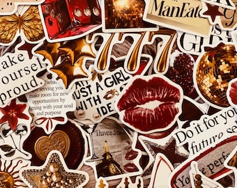 May include: A collection of assorted stickers featuring a red die, gold stars, a disco ball, a pair of red lips, a wax seal, a martini glass, and text phrases including "Make yourself proud," "She's a ManEater," and "Do it for your future self."