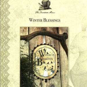 May include: A cross-stitch pattern featuring a winter scene with birds and the text "Winter Blessings". The pattern is framed in a round wooden hoop with a beaded border.