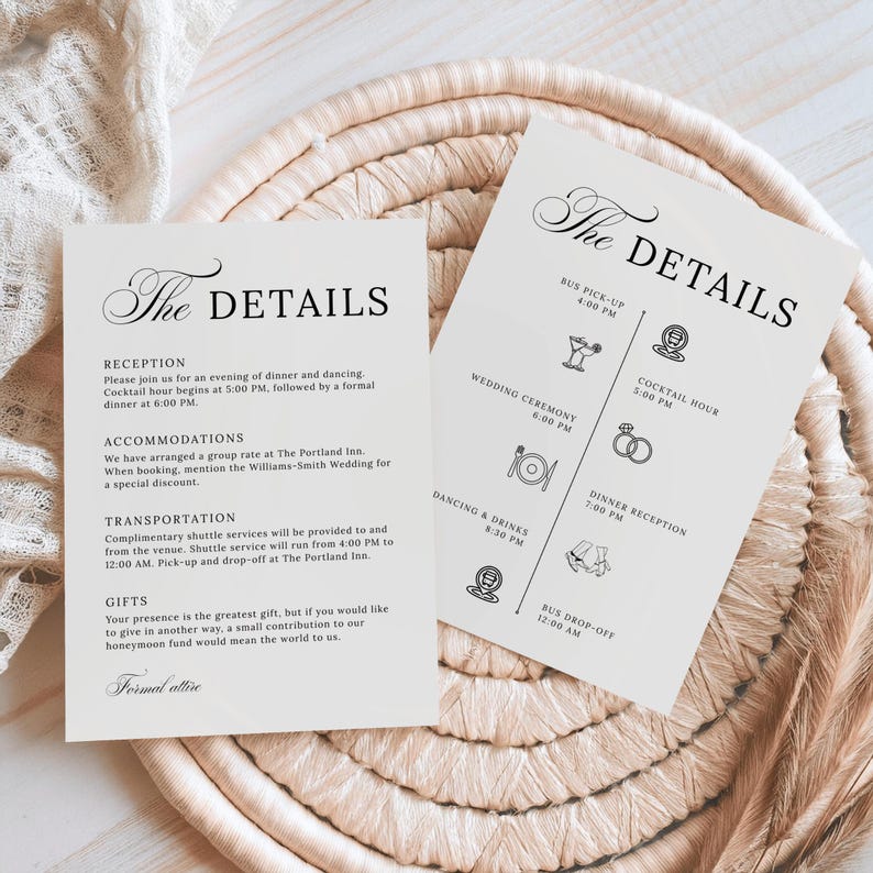 Flat lay of two minimalist black and white wedding detail cards displayed on a woven placemat with lace fabric. One card lists reception, accommodations, transportation, and gift info in a formal serif layout, while the second features a timeline with icons for each event, from bus pickup to dancing and drinks.