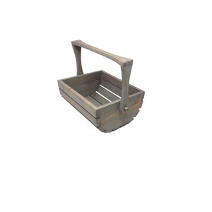May include: A gray wooden basket with a handle. The basket is made of slats and has a rounded bottom.