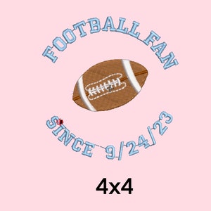 May include: A light pink background with a blue and white embroidered design of a football, the words "FOOTBALL FAN" and "SINCE 9/24/23" in a circle around the football. The text "4x4" is below the circle.