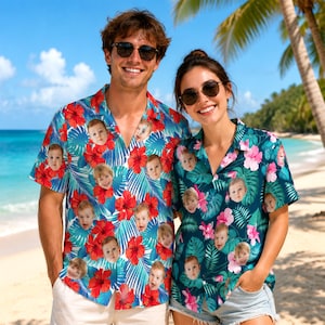 May include: Two short-sleeved button-down shirts featuring a tropical pattern of red and pink hibiscus flowers and green palm leaves, customised with a repeating photographic print of a young child's face throughout the fabric design.