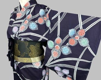 May include: A dark blue and white patterned yukata with a floral design. The yukata has a black obi with gold accents.