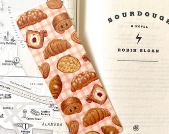 Marcador de Páginas Croissant e Doces: Marcador de páginas laminado, divertido e com bordas arredondadas, perfeito para amantes da gastronomia.