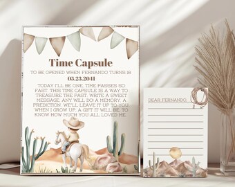 May include: A time capsule set with a desert theme. The main piece has text that reads "Time Capsule" and "To be opened when Fernando turns 18 05.23.2041". The image includes a cowboy on a horse, cacti, and a letter to "Dear Fernando".