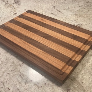 Handmade hardwood cutting board walnut, and cherry with juice groove (made by teen woodworker)
