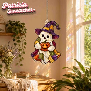 May include: A stained glass suncatcher featuring a ghost wearing a purple witch hat and holding an orange jack-o'-lantern. The ghost is decorated with a colourful patchwork pattern in shades of purple, orange, yellow, and green. Text reads Patricia Suncatcher.