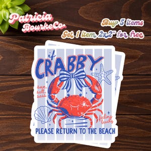 May include: A stack of stickers with a crab design. The crab is red with blue accents, a blue bow, and the words "If Crabby" above it. The stickers also say "Please Return to the Beach."