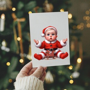 May include: A Christmas card featuring a baby dressed in a Santa Claus outfit. The baby is wearing a red suit with white trim, a black belt, and a Santa hat. The baby is sitting with its arms raised. The card has the text "CHARTGALLERY".