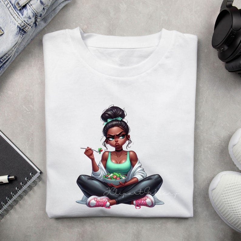 May include: White t-shirt featuring a cartoon illustration of a woman with a bun, wearing a teal top, black pants, and pink sneakers, eating a salad. The illustration includes the text "KlipartGalDesign".