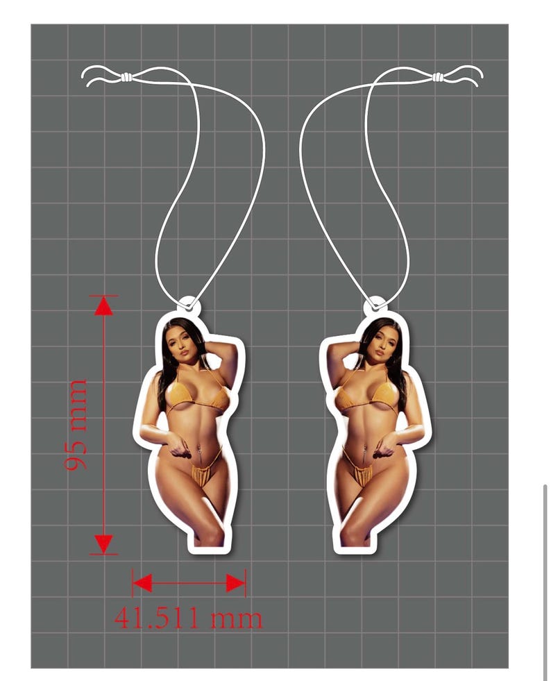 May include: Two identical air fresheners featuring a photographic print of a person with long dark hair wearing a mustard yellow bikini. Each air freshener has a white hanging string and measures 95 mm in height and 41.511 mm in width.