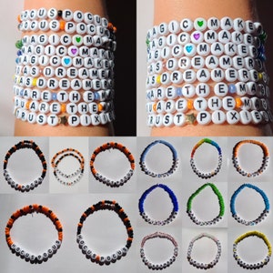 May include: A set of 12 colorful beaded bracelets with various phrases, including "Hocus Pocus", "Magic Maker", "You Are The Magic", and "Trust The Pixie".