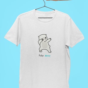 Pode incluir: Camiseta branca com uma ilustra&ccedil;&atilde;o de desenho animado de um urso polar fazendo o dab. O texto "Polar Brrr" est&aacute; impresso abaixo do urso.