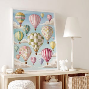 May include: A watercolour painting of colourful hot air balloons floating in a blue sky with white clouds. The balloons are various shapes and sizes, with patterns like polka dots, stripes and chequered designs.