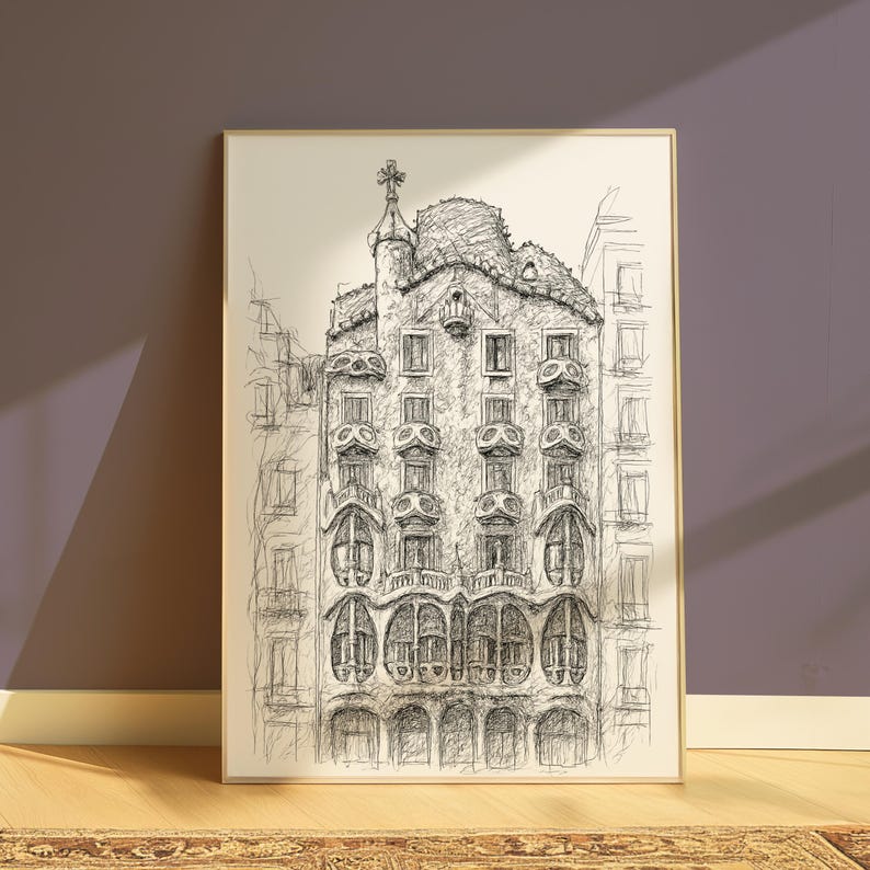 May include: A framed black and white pen and ink drawing of a building with ornate architectural details. The artwork depicts a multi-story structure with rounded windows, balconies, and a decorative rooftop. The drawing is displayed on a wall.