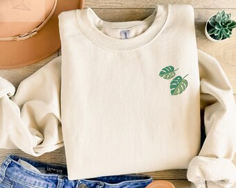 Embroidered monstera sweater in a cozy unisex fit with a clean botanical design