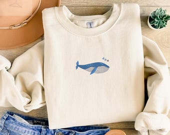 Embroidered whale sweatshirt in a soft cozy unisex fit with a simple ocean design