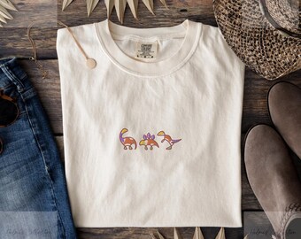 Embroidered dinosaur t-shirt with a simple line art style