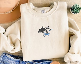 Embroidered orca whale sweatshirt in a soft cozy unisex fit with a dynamic ocean design