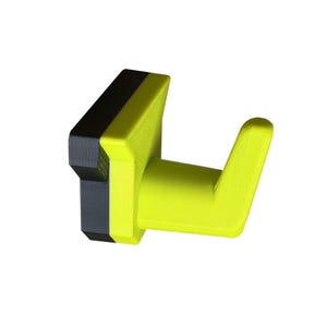 May include: A wall-mounted hook in a modern design. The hook features a bright yellow arm and a black and gray rectangular base. The hook is made of a solid material and is designed for hanging items.