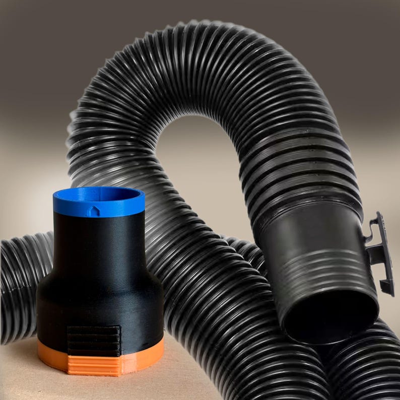May include: Black corrugated flexible hose with a black and orange adapter and a blue rim. The hose is curved and has a ribbed texture. The adapter is cylindrical and has a hexagonal base. The items appear to be made of plastic.