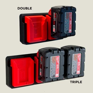 May include: A black wall mount with two and three slots for holding Milwaukee M18 12.0V lithium-ion batteries. The slots are red and black. The text "DOUBLE" and "TRIPLE" are printed below the wall mounts.