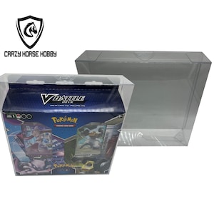 May include: A clear plastic display case with a Pokemon V Battle Deck featuring Mewtwo vs. Mew. The deck is blue and features images of Mewtwo and Mew. The case is designed to protect the deck and display it.