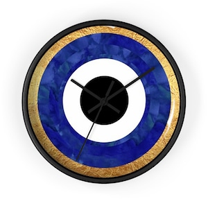 May include: A round wall clock with a blue and white evil eye design. The clock has a black frame and gold accents.