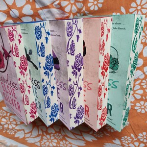 May include: A set of six paperback books with a rose pattern on the cover. The books are titled "Flawless", "Else", "Silver", "Less", "If", "Ever", and "After".