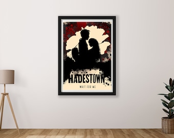 May include: A black and white poster with a silhouette of two people sitting under a large white flower. The poster has a red and black splatter paint background and the text "Hadestown Wait For Me".