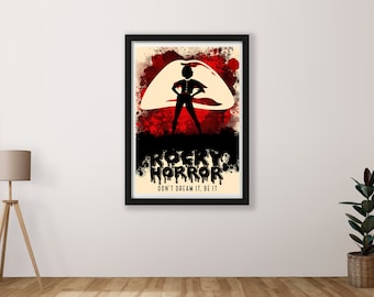 May include: A black and white poster with a red and white splatter background. The poster features a silhouette of a woman standing in front of a large, open mouth with teeth. The text "Rocky Horror" is written in black dripping letters. The text "Don't dream it, be it" is written in black below the title.
