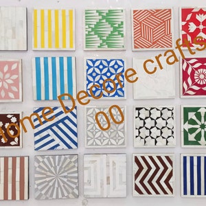 May include: Set of 16 decorative tiles with various geometric patterns and colors, including white, black, blue, red, green, and yellow. The tiles are made of mother of pearl and are perfect for adding a touch of elegance to any home decor project.