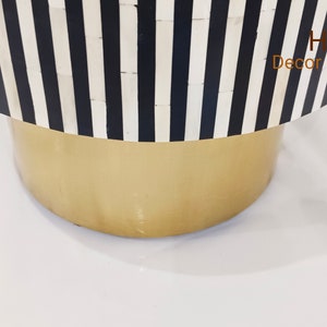 May include: A black and white striped round table with a gold base. The table is made of bone inlay and has a modern design. Home Decor Crafts00 is printed on the table.