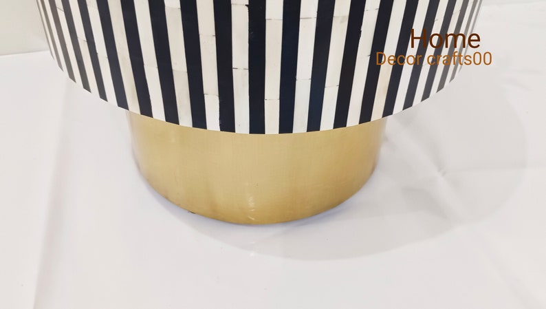 May include: A black and white striped round table with a gold base. The table is made of bone inlay and has a modern design. Home Decor Crafts00 is printed on the table.