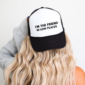 Funny country trucker hat with phrase I’m the Friend in Low Places, unisex adjustable mesh cap, western humor gift for men and women